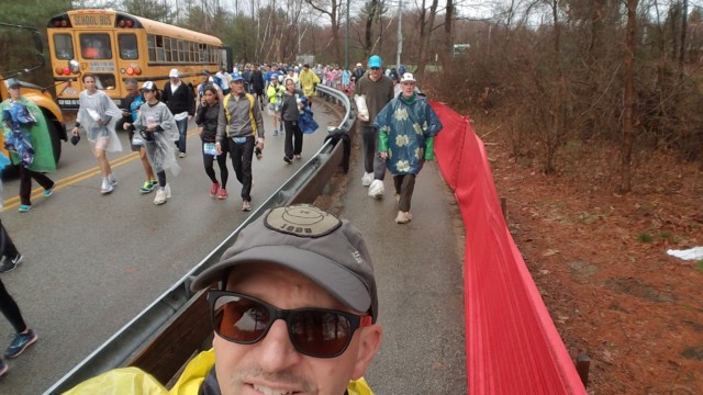 Off the bus, trying to keep dry during the walk.